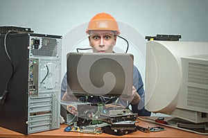 Repairman working on laptop computer.