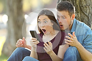 Surprised couple finding amazing content on line