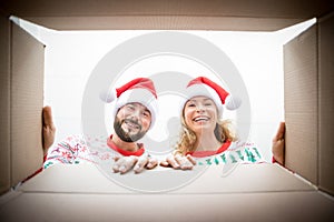Surprised couple unpack Christmas gift box