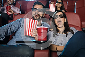 Surprised couple watching a 3d movie