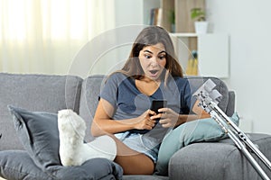 Surprised disabled woman reading phone content