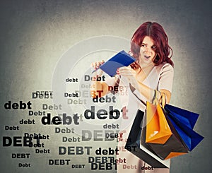 Surprised and disappointed young woman has a empty wallet, overspending money on shopping. Shocked about huge debt amount. Sale