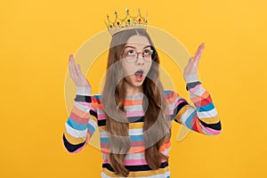 surprised egoistic kid in glasses wear queen crown on yellow background, surprise