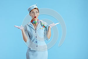 surprised elegant air hostess woman on blue