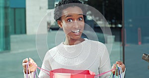 Surprised enthusiastic joyful woman african american girl afro mixed race student shopper consumer looking in shopping