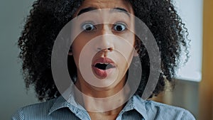 Surprised ethnic african american young woman open mouth in delight surprise expressing shock ecstatic facial emotion