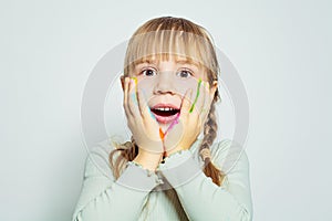 Surprised excited child girl art school student on white background portrait