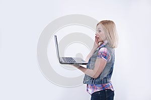 Surprised and excited young women looking on laptop screen.