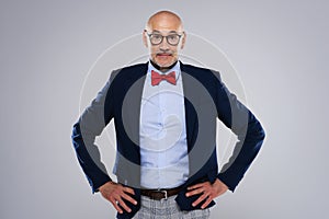 Surprised face man wearing bow tie and suit while standing at isolated background