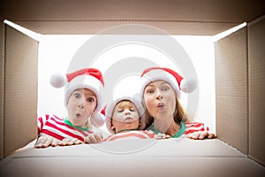 Surprised family unpack Christmas gift box