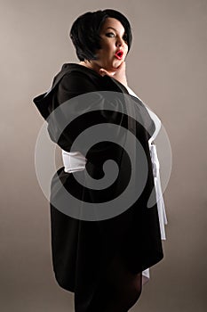 Surprised fat woman in black and white dress