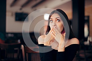 Polite Woman Covering Her Mouth at the Table photo