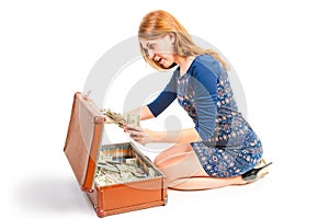 Surprised girl found in suitcase of money