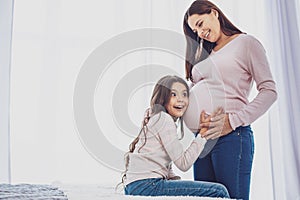 Surprised girl and her pregnant mother