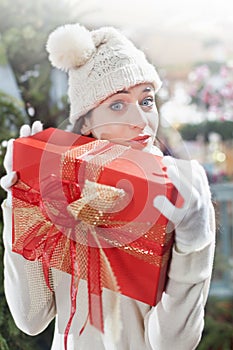 Surprised girl, holding tight, her gift