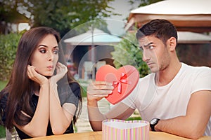 Surprised Girl Receiving Heart Shaped Gift from her Boyfriend