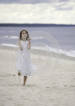 Surprised girl is running on the beach