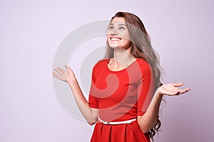 Surprised girl. Sincere joy. Beautiful brunette. Red dress