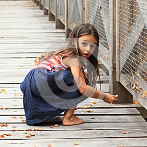 Surprised girl on wooden bridge