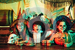 Surprised group little zombie in Halloween costume eating treat - calaverita sweets candles. Funny Halloween. Halloween photo