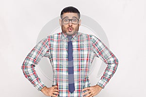 Surprised handsome bearded businessman in checkered shirt, blue