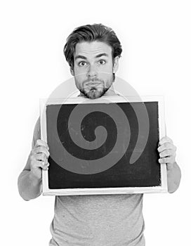 Surprised handsome man holding blackboard isolated on white back