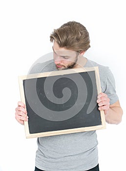 Surprised handsome man holding blackboard isolated on white background