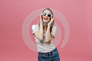 Surprised happy beautiful woman looking in excitement. Isolate over pink background and copy space.