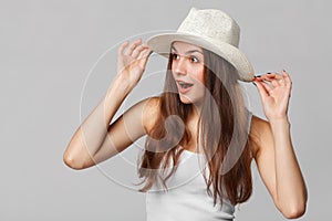 Surprised happy beautiful woman looking sideways in excitement. on gray background