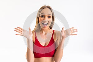 Surprised happy beautiful woman looking sideways in excitement on white background