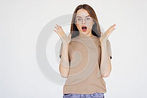 Surprised happy beautiful woman looking sideways in excitement on white background