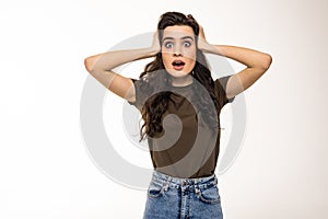 Surprised happy beautiful woman looking sideways in excitement on white background