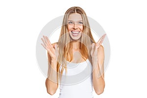 Surprised happy beautiful young woman looking up in excitement. Isolated over white photo