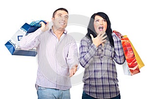 Surprised happy couple with shopping bags