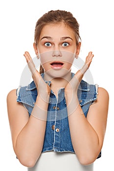 Surprised happy teenager girl in excitement. Isolated over white background