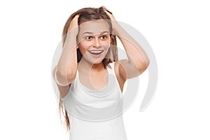 Surprised happy teenager girl looking to side in excitement. Isolated over white background