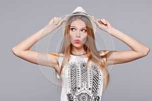 Surprised happy young woman looking sideways in excitement. Isolated over gray