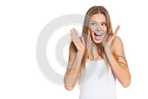 Surprised happy young woman looking sideways in excitement. Isolated over white