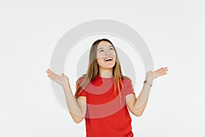 Surprised happy young woman looking sideways in excitement over white background