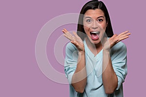 Surprised and joyful female portrait, woman shocked with happy expression on her face, copy space advertising