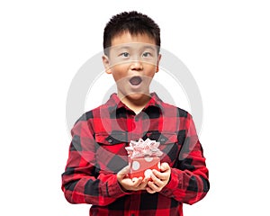 Surprised kid with hand holding christmas gift box isolated on white background