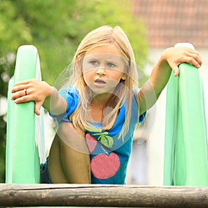 Surprised little girl on a slide