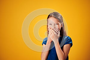 Surprised Little Redhead Girl Smiling And Covering Mouth