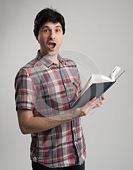 Surprised man with book