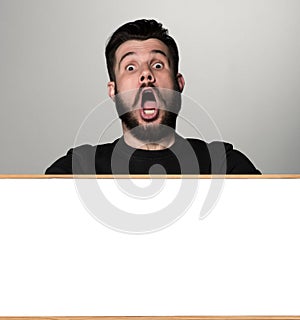 The surprised man and empty blank over gray