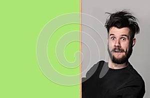 The surprised man and empty blank over gray background