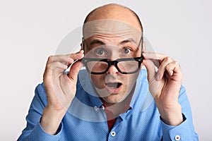 Surprised man in eyeglasses looking at camera photo