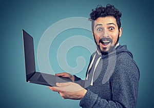 Surprised man with laptop computer