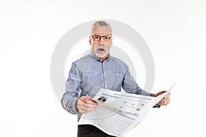 Surprised man looking camera with opened mouth and holding newspaper