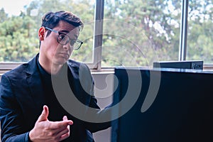 Surprised man looking at his computer monitor. Man in the office working with his computer. Young blond Caucasian man